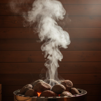 Soft steam cloud drifting above the stove stones